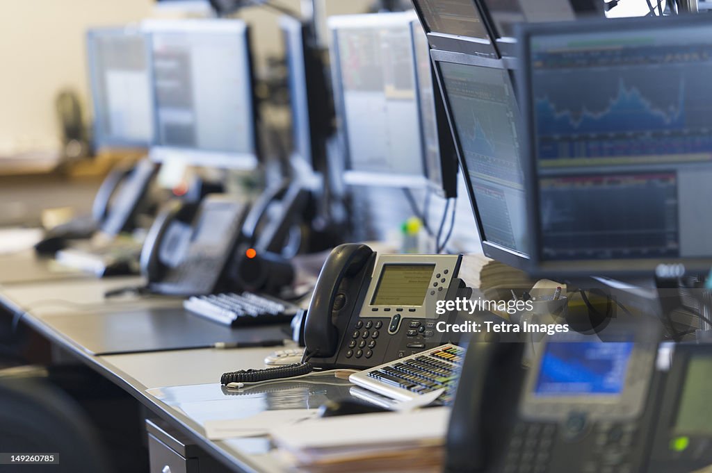 USA, New York, New York City, Trading desk with computers and phones