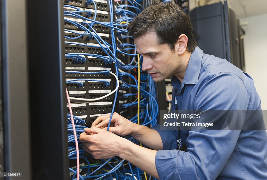 USA, New York, New York City, Technician inspecting network server