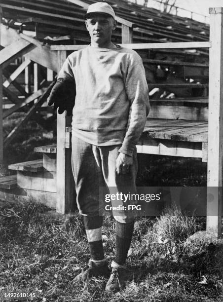 American baseball player Henry Feldcamp, a one-armed pitcher for the University of Missouri, holding his glove over the stump of his missing right...