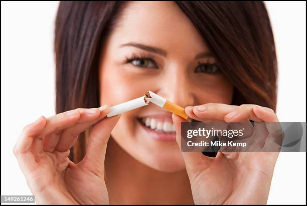 Young Woman Breaking Cigarette High-Res Stock Photo