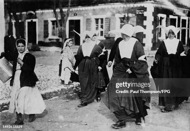 French nuns in the service of the Red Cross during the First World War, in an unspecified small town in the south of France, circa 1916. Each of the...