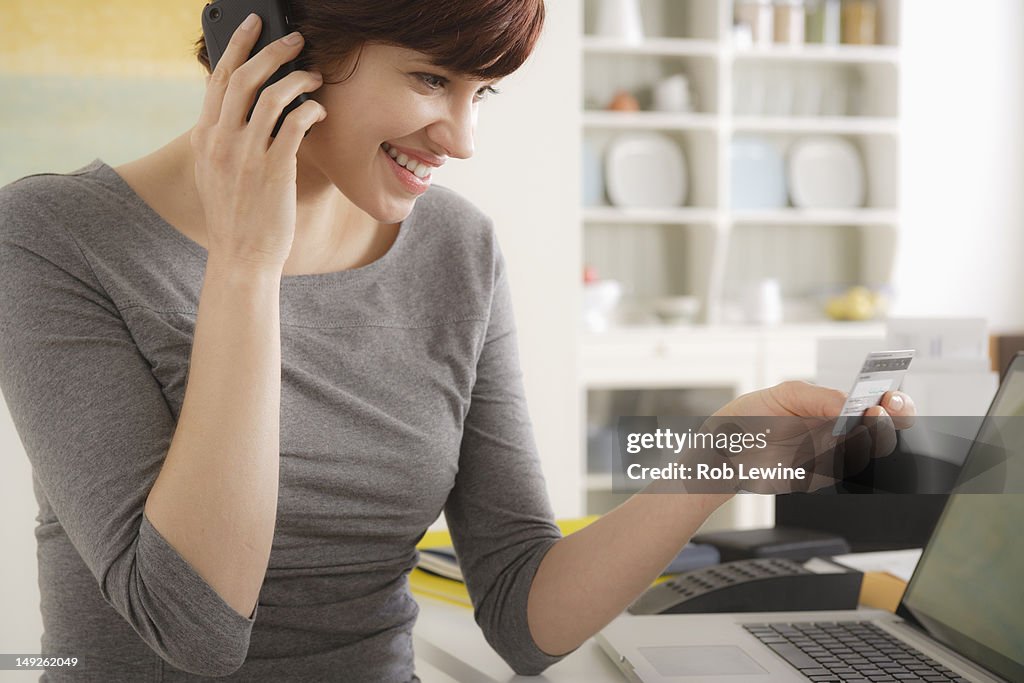 USA, California, Los Angeles, Young woman talking via mobile at home