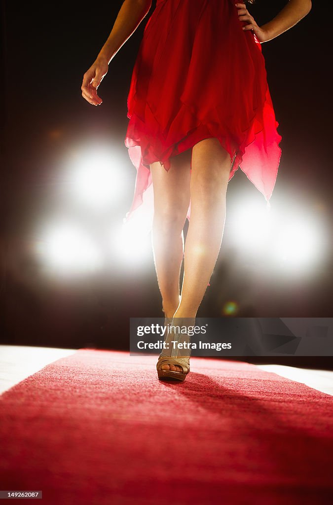 Woman wearing red dress on catwalk