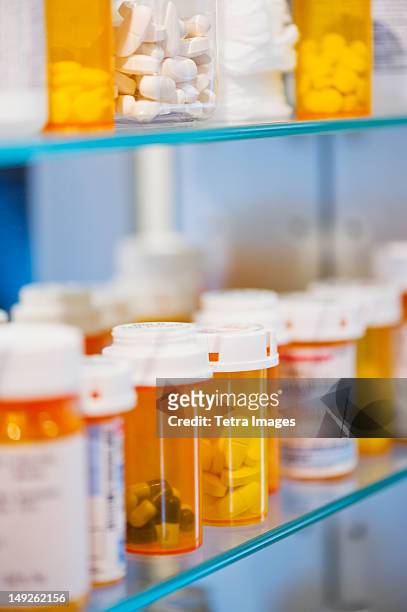 pill bottles on shelf - medicine cabinet stock pictures, royalty-free photos & images