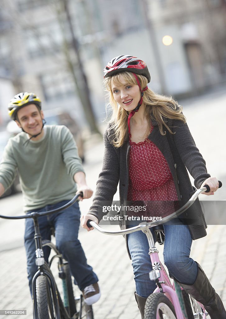 USA, New Jersey, Jersey City, Couple cycling on street