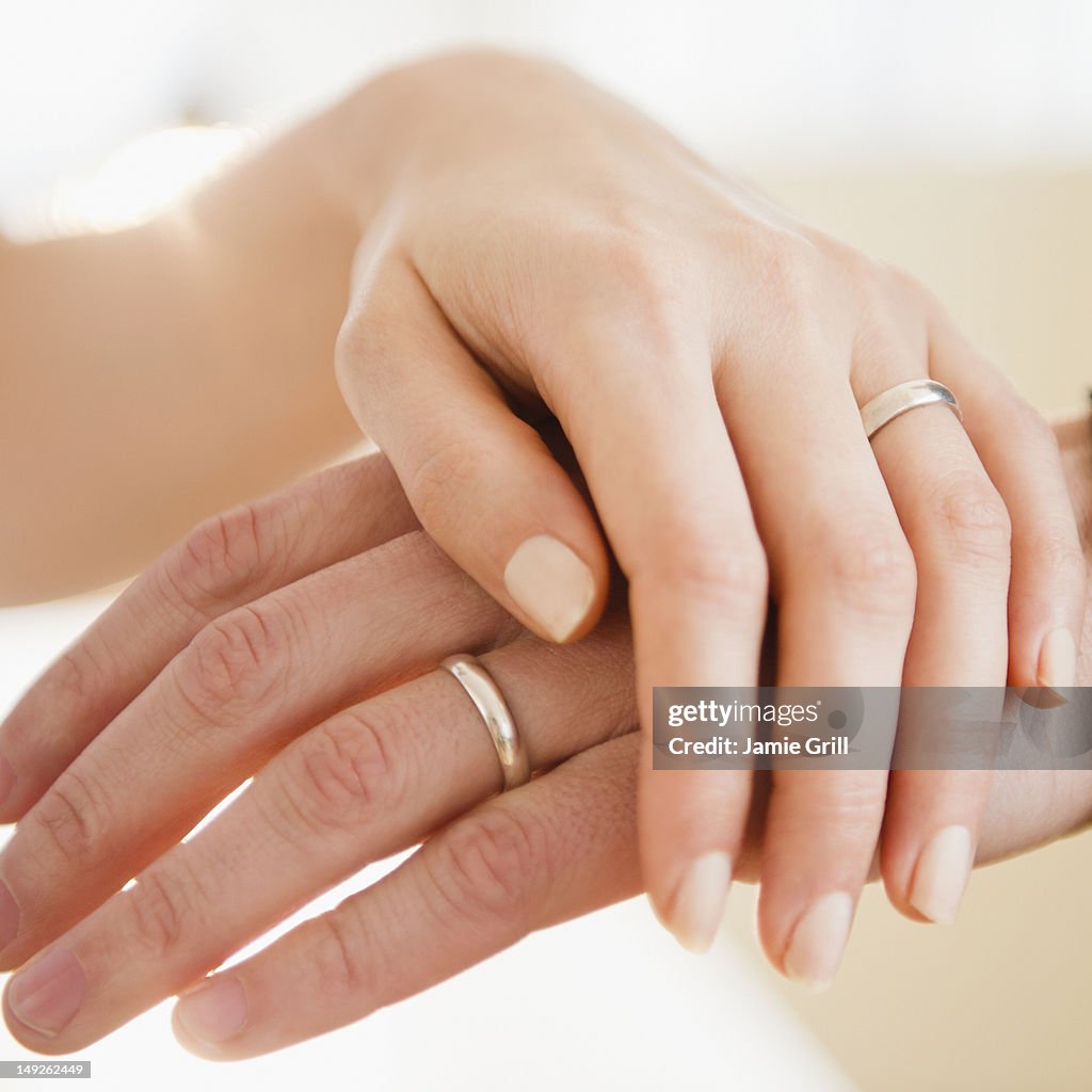 USA, New Jersey, Jersey City, Close up of man's and woman's hands with wedding ring