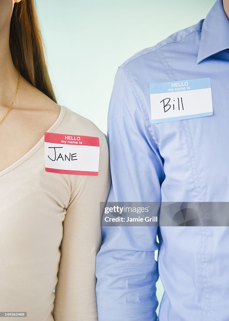 Close up of man and woman standing arm in arm, studio shot