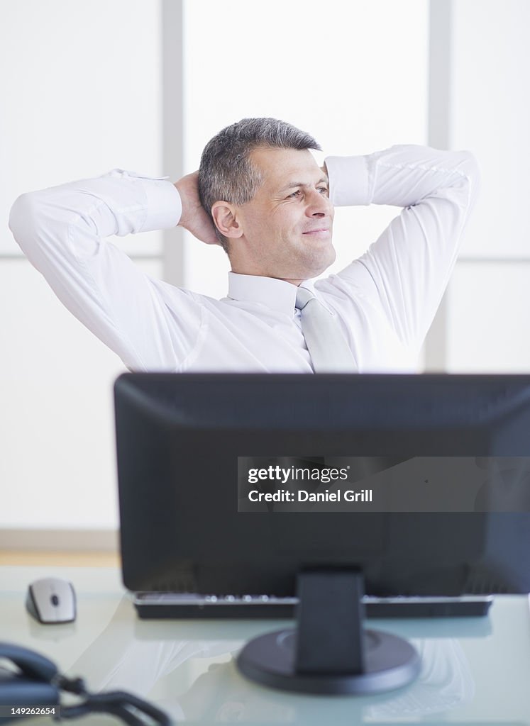 Portrait of businessman relaxing at desk