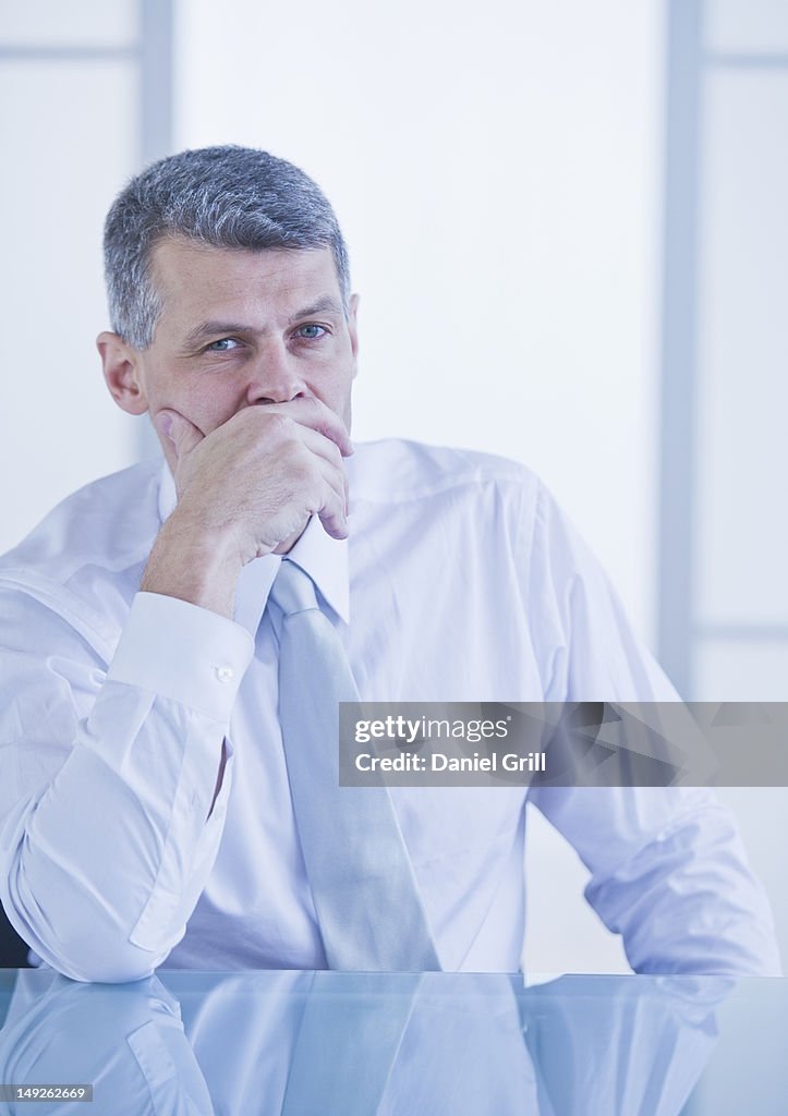 Portrait of businessman sitting at desk