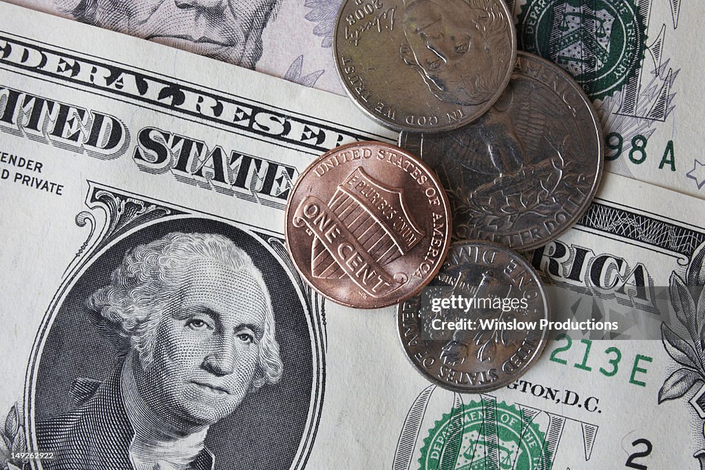 Close-up of dollar banknotes and coins