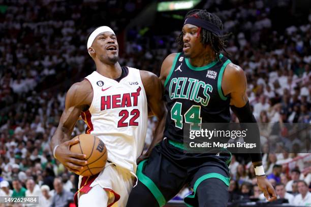 Jimmy Butler of the Miami Heat drives against Robert Williams III of the Boston Celtics during the third quarter in game three of the Eastern...