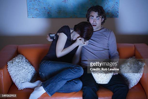 usa, california, los angeles, young couple watching tv - watching tv couple night stock pictures, royalty-free photos & images