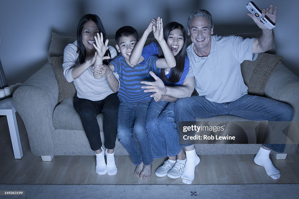 USA, California, Los Angeles, Family sitting on sofa and watching television