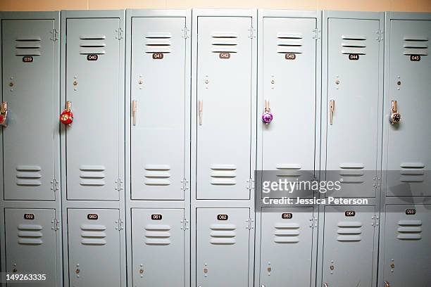 row of lockers with different padlocks - spind stock-fotos und bilder