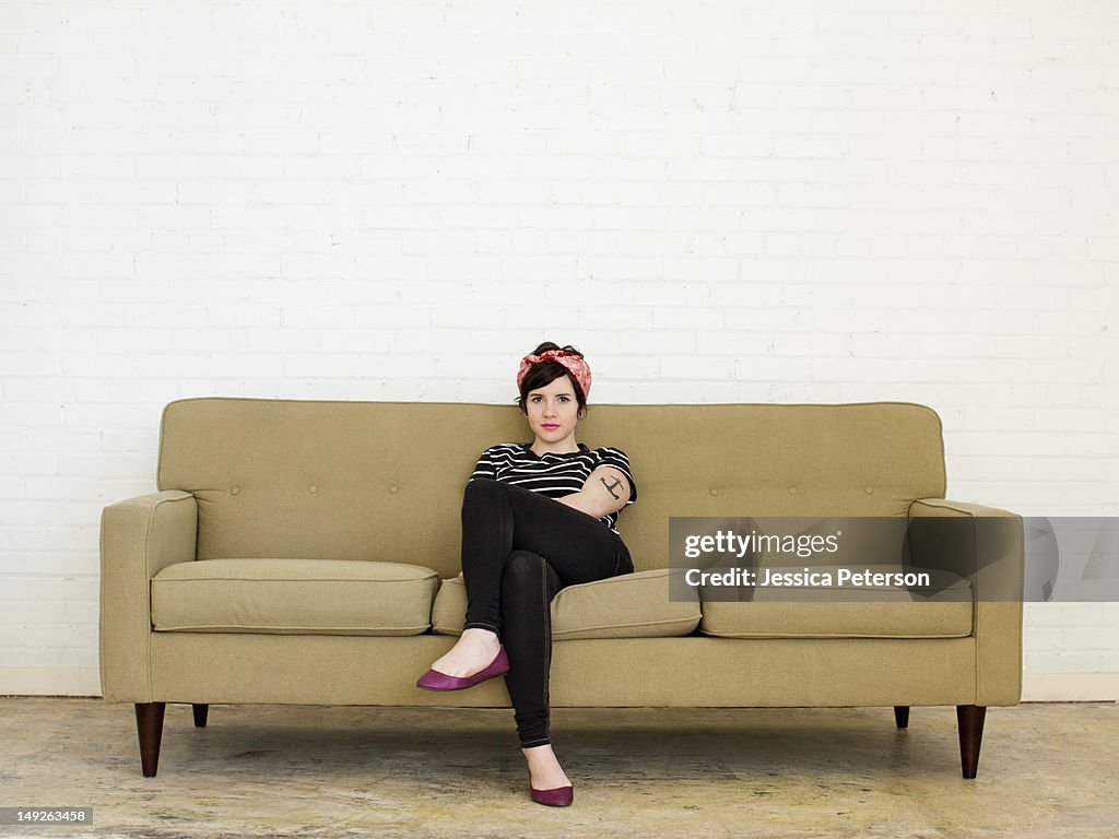 Young woman sitting on sofa