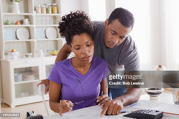 usa, california, los angeles, couple doing finances together - woman look straight black shirt stock pictures, royalty-free photos & images