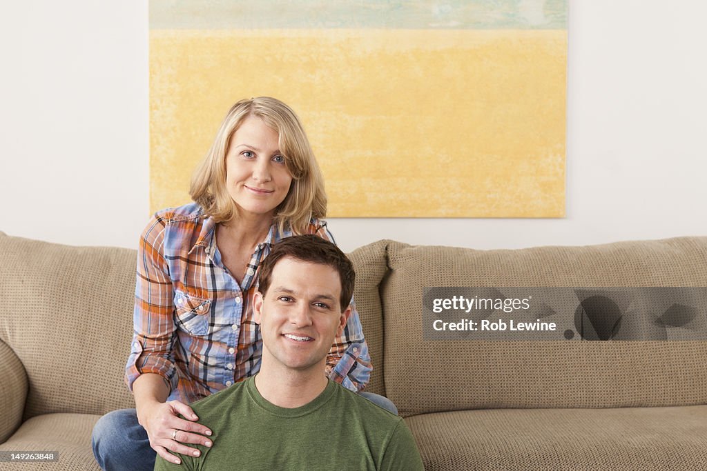 USA, California, Los Angeles, Smiling mid adult couple sitting on sofa