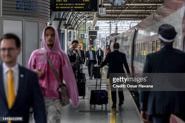 Passengers arriving from Paris-Nord on the Thalys train walk along the platform towards the exit of the Gare Du Midi station on May 23, 2023 in...