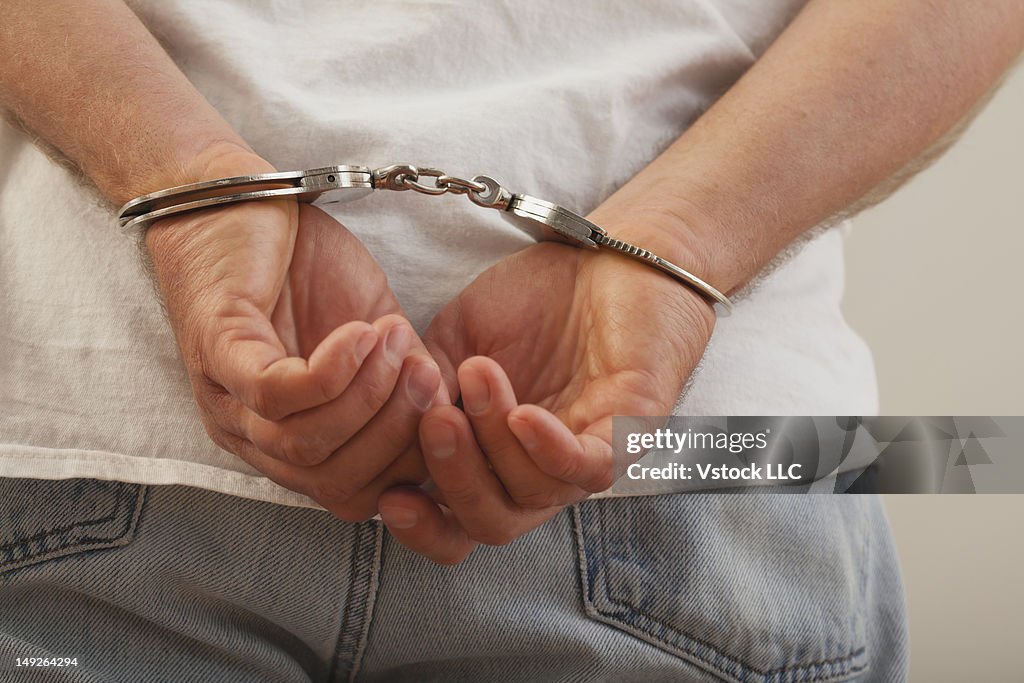 Hands in handcuffs, close-up