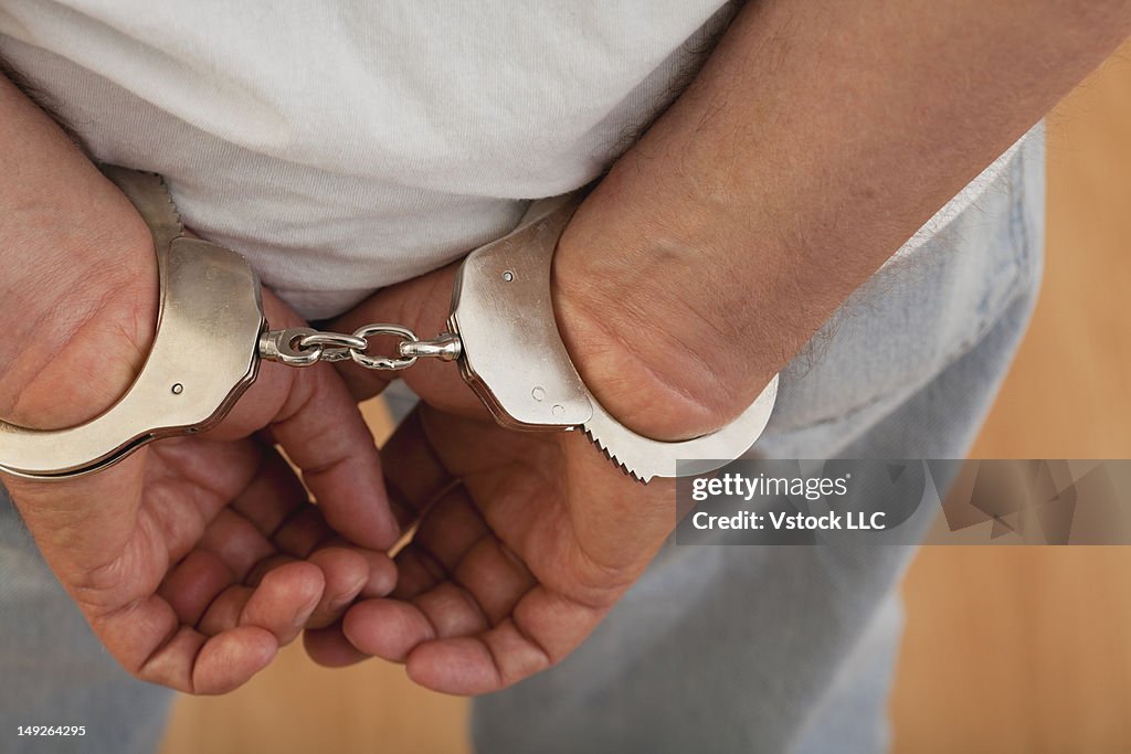 Hands in handcuffs, close-up