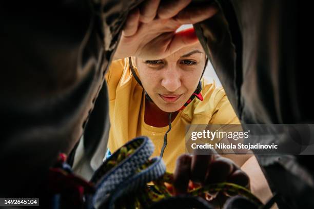 woman preparing  backpack for a climbing - open backpack stock pictures, royalty-free photos & images