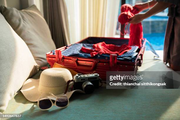 woman packing suitcase for summer trip. - hotel reopening stock pictures, royalty-free photos & images