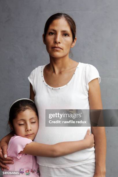 mexican mother and daughter hugging. - serious kid stock pictures, royalty-free photos & images