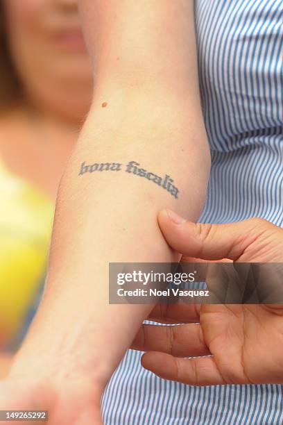 Katee Sackoff displays her tattoos at "Extra" at The Grove on July 25, 2012 in Los Angeles, California.