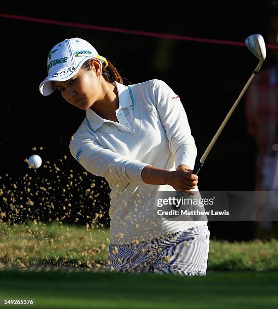 Ai Miyazato of Japan plays out of the bunker on the 1st hole during day one of the Evian Masters at the Evian Masters Golf Club on July 26, 2012 in...