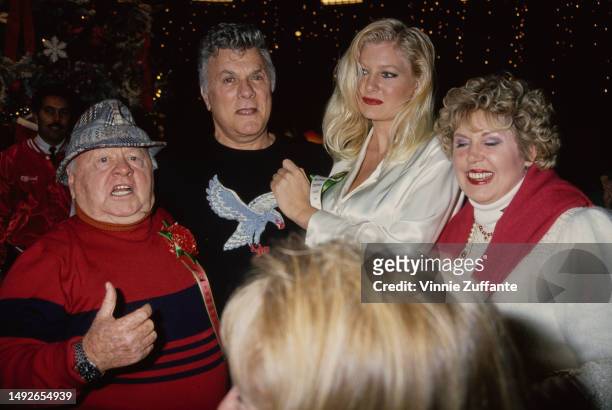 Mickey Rooney and Tony Curtis with friends and family at the Hollywood Christmas Parade, Los Angeles, California, United States, December 1994.