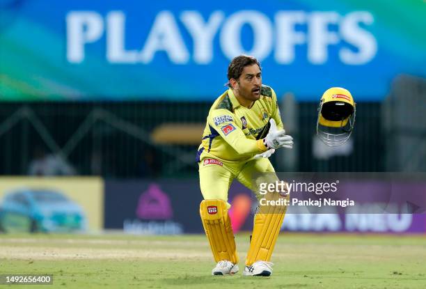 Mahendra Singh Dhoni of Chennai Super Kings catches their helmet whilst fielding during the IPL Qualifier match between Gujarat Titans and Chennai...