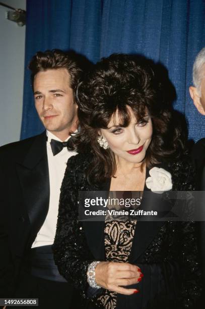 Luke Perry, Joan Collins and Aaron Spelling attend an event, United States, circa 1980s.