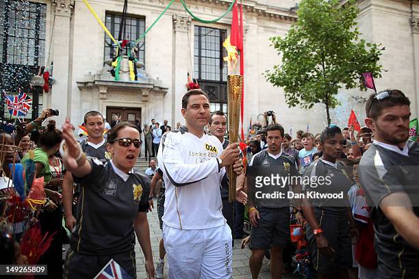 Comedian David Walliams sets off with the Olympic Torch from Islington Town Hall on day 69 of the London 2012 Olympic Torch Relay on July 26, 2012 in...