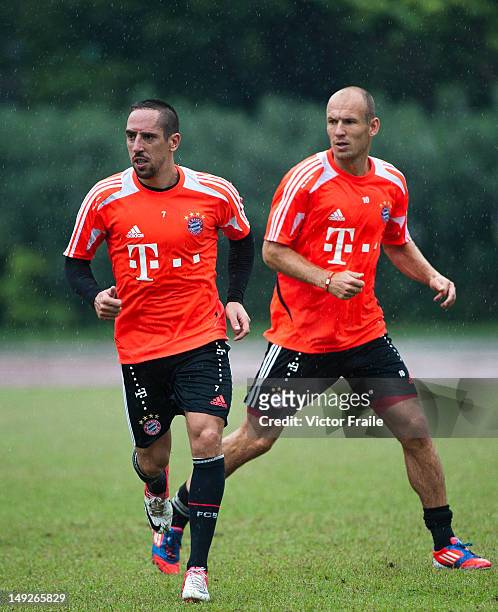 Arjen Robben and Franck Ribery of Bayern Muenchen in action during a training session ahead the friendly match against VfL Wolfsburg as part of the...
