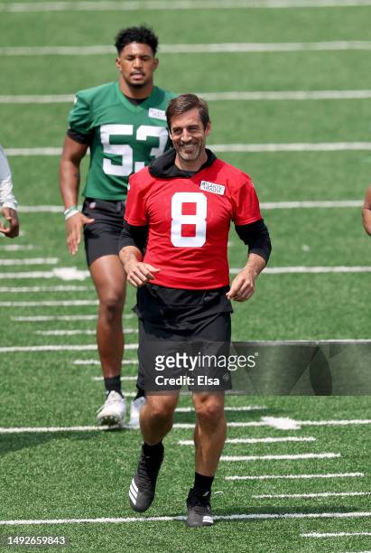 Aaron Rodgers and Zaire Barnes of the New York Jets warm up during an offseason workout session at Atlantic Health Jets Training Center on May 23,...