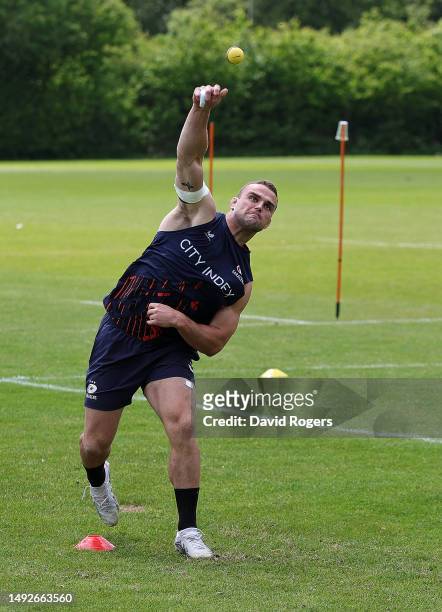 Ben Earl bowls the ball during a game of cricket during the warm up prior to the Saracens training session held on May 23, 2023 in St Albans, England.