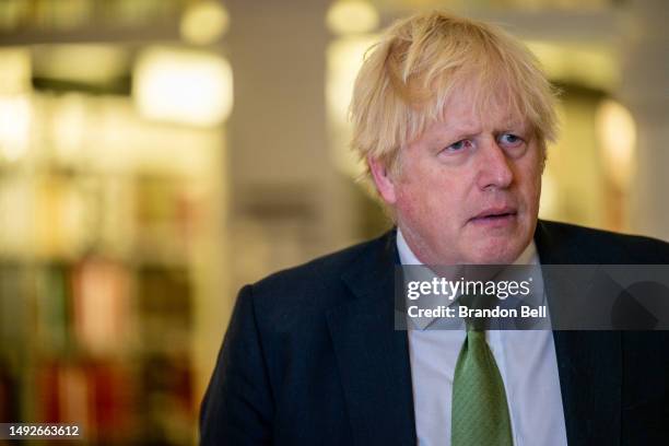 Former UK Prime Minister Boris Johnson listens during a tour after a meeting with Gov. Greg Abbott at the Texas State Capitol on May 23, 2023 in...