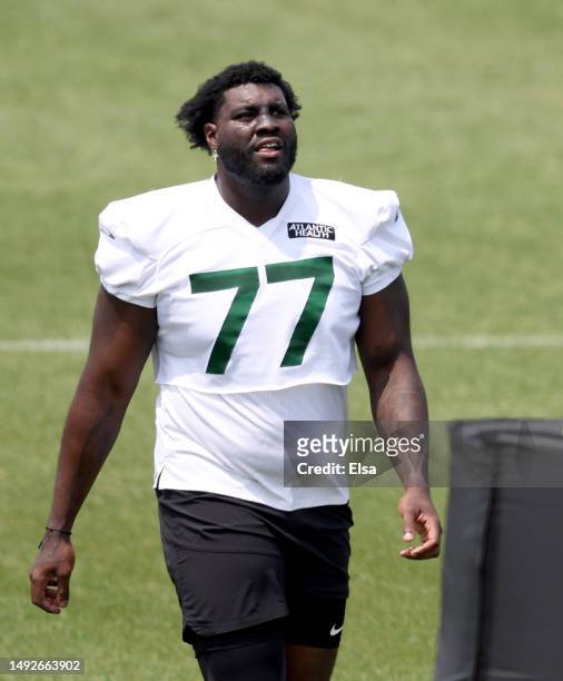 Mekhi Becton of the New York Jets walks on the field during an offseason workout session at Atlantic Health Jets Training Center on May 23, 2023 in...