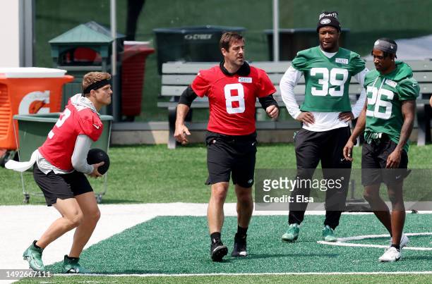 Aaron Rodgers of the New York Jets reacts after a medicine ball warm up drill as Zach Wilson works out during an offseason workout session at...