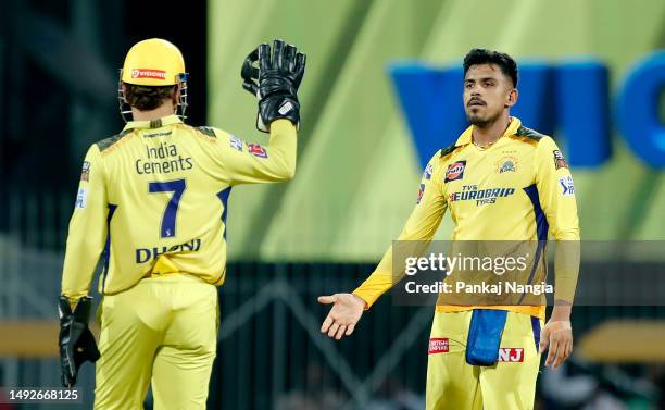 Maheesh Theekshana of Chennai Super Kings celebrates with teammate Mahendra Singh Dhoni after taking the wicket of Rahul Tewatia of Gujarat Titans...