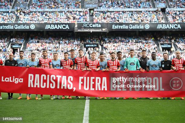 Players of both teams and match officials pose for a photo for a photo with a banner against racism prior to the LaLiga Santander match between RC...