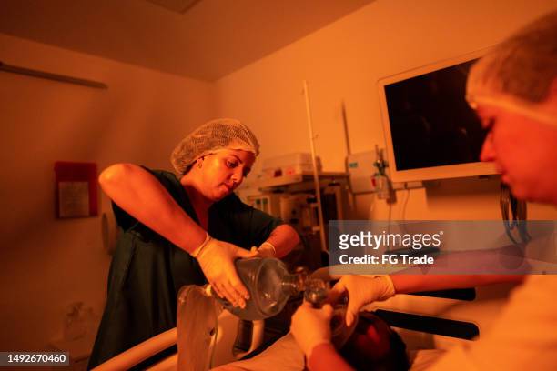 doctor using manual ventilator in the patient in the hospital - hospital ventilator stock pictures, royalty-free photos & images