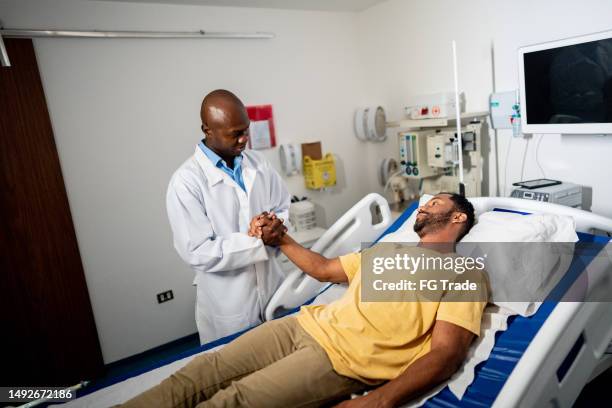 médico conversando com um paciente no hospital - medicina intensiva - fotografias e filmes do acervo