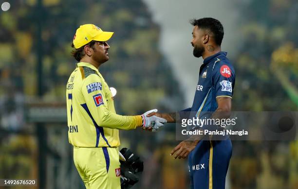 Mahendra Singh Dhoni of Chennai Super Kings shakes hands with Hardik Pandya, Captain of Gujarat Titans after the IPL Qualifier match between Gujarat...