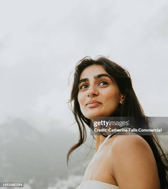 low angle view of a young indian woman outside - female piercing fotografías e imágenes de stock