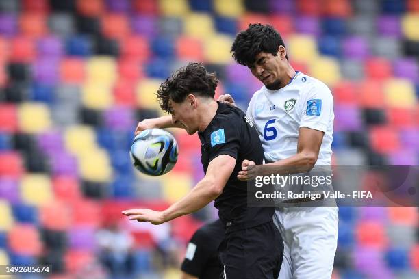 Isaac Hughes of New Zealand battles for the ball Jakhongir Urozov of Uzbekistan during the FIFA U-20 World Cup Argentina 2023 Group A match between...