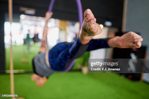 close-up of woman feet in aerial hoop in gym - lyra stock pictures, royalty-free photos & images