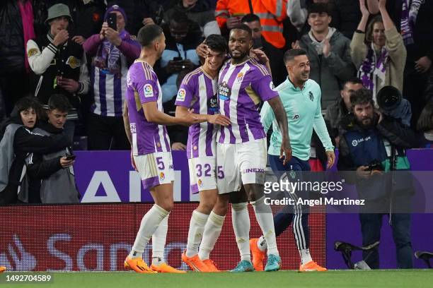 Cyle Larin of Real Valladolid CF celebrates with teammates Javi Sanchez and David Torres after scoring the team's second goal from the penalty spot...
