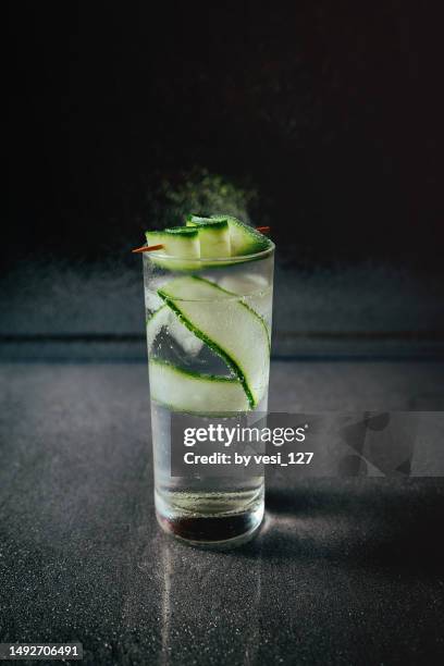 fresh cocktail with cucumber on dark background - cucumber cocktail stock pictures, royalty-free photos & images