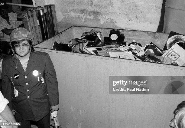 American disc jockey Steve Dahl stands beside of a crate full of unwanted disco records collected during an anti-disco promotion at Comiskey Park,...